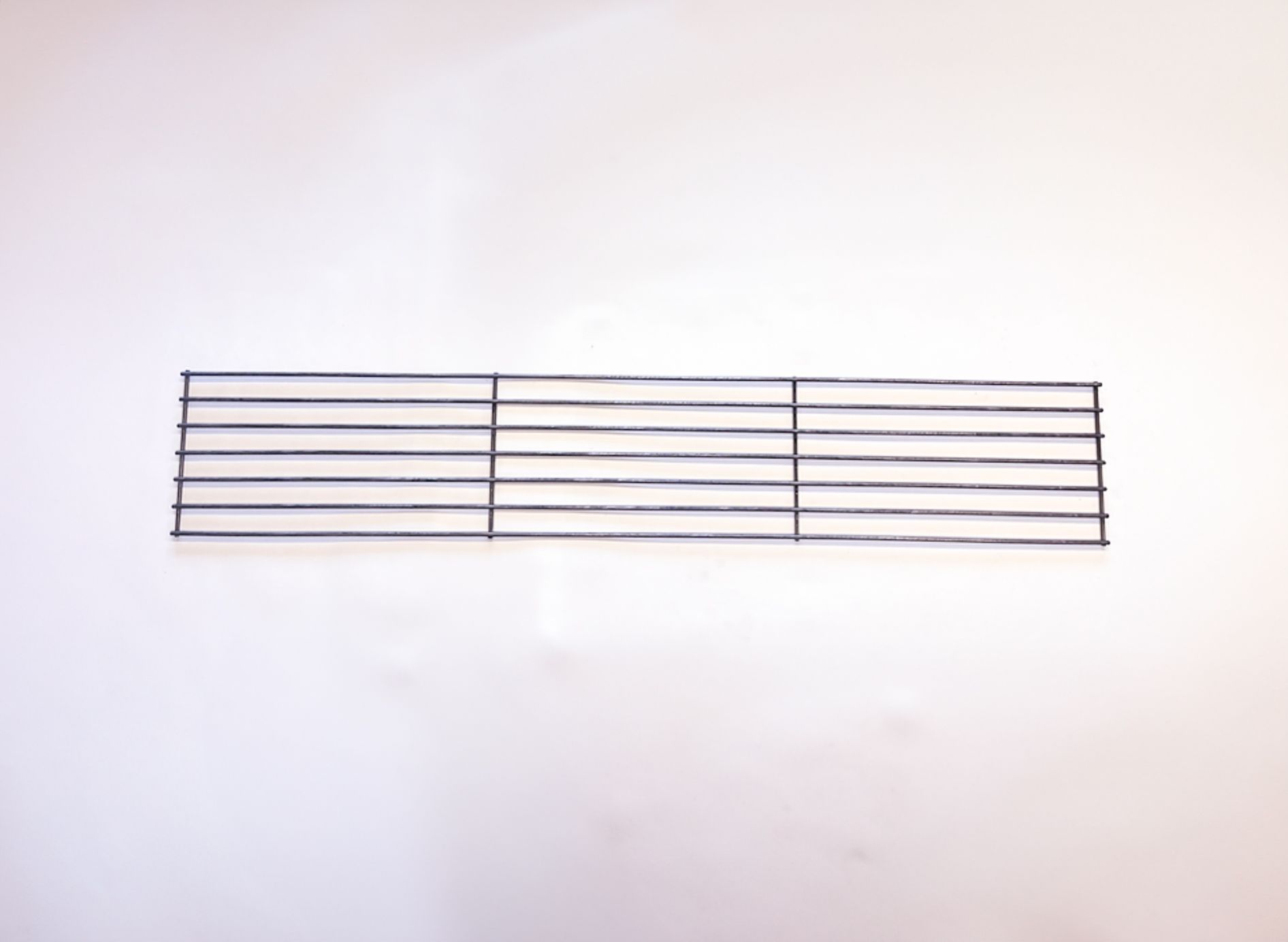 Black metal grill on a white background.