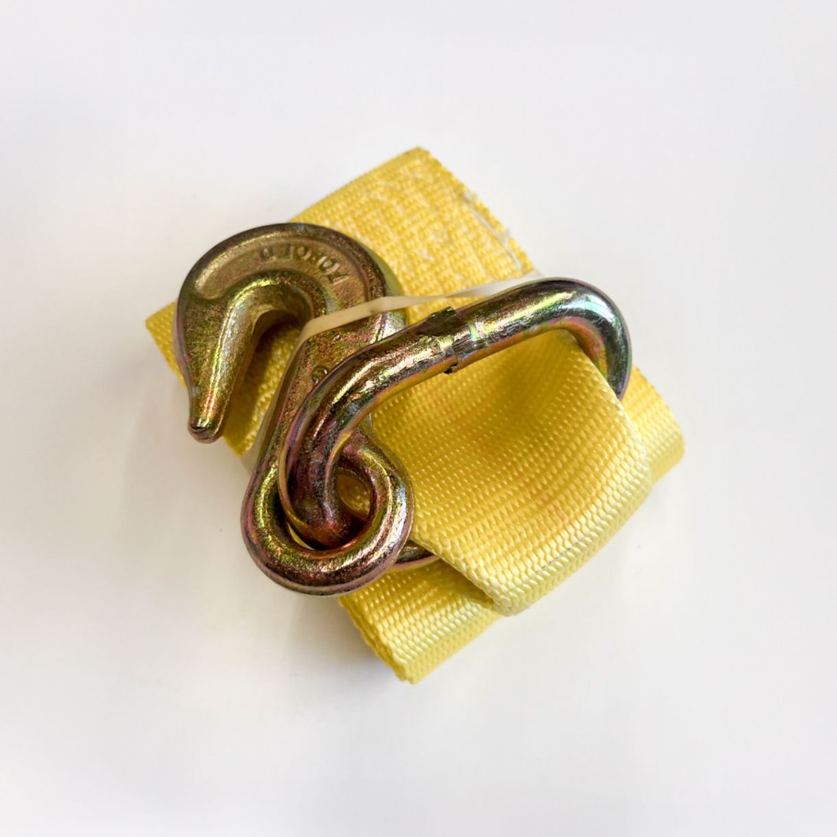 Yellow strap with metal hook, used for securing cargo.