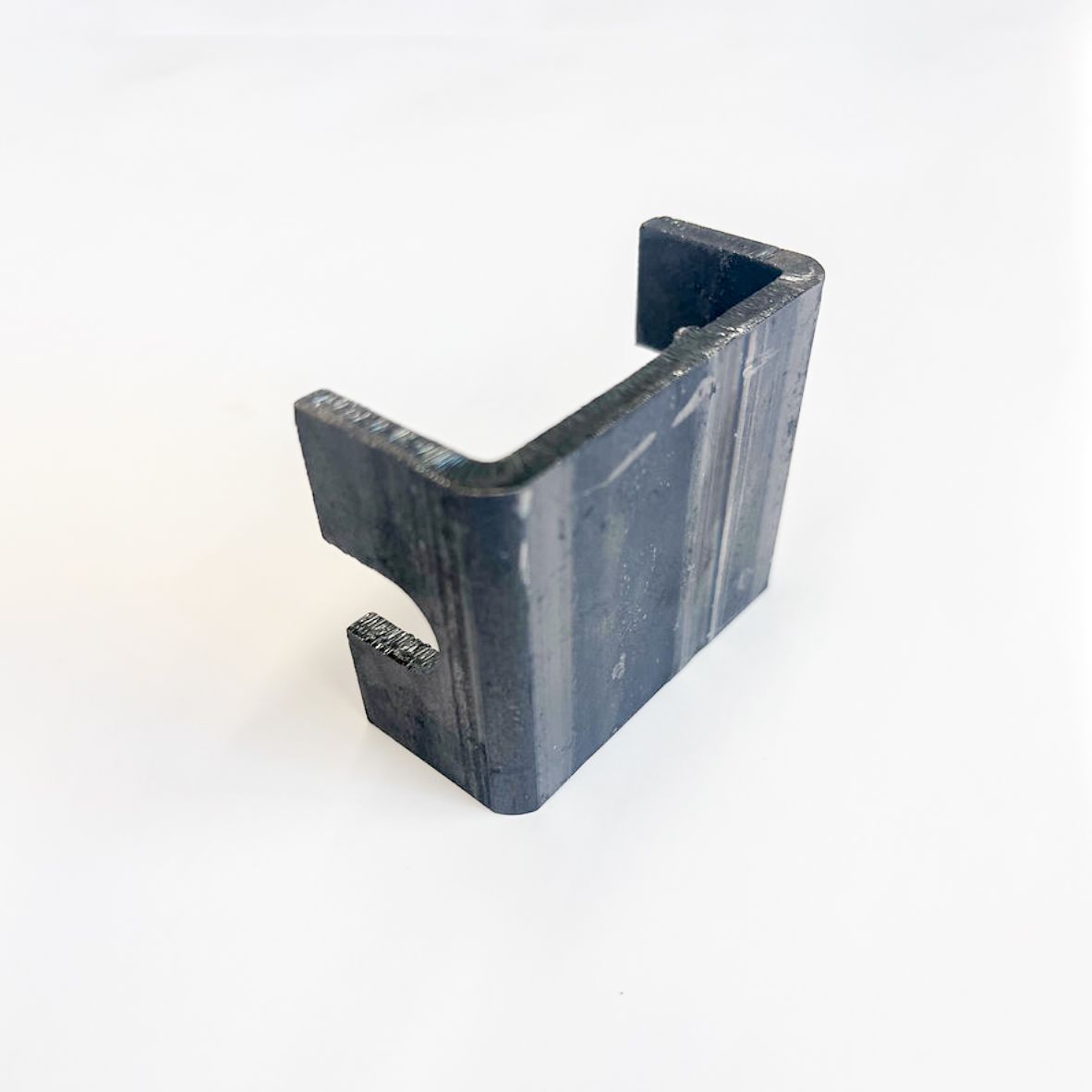 Black metal bracket with a curved cutout on a white surface.
