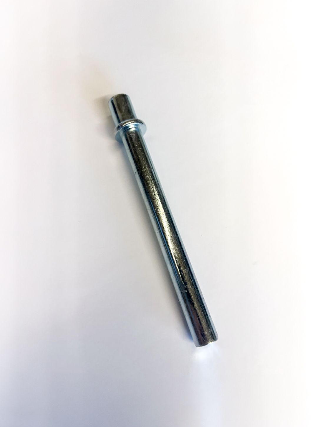 Silver metal pin with a circular head on a white background.