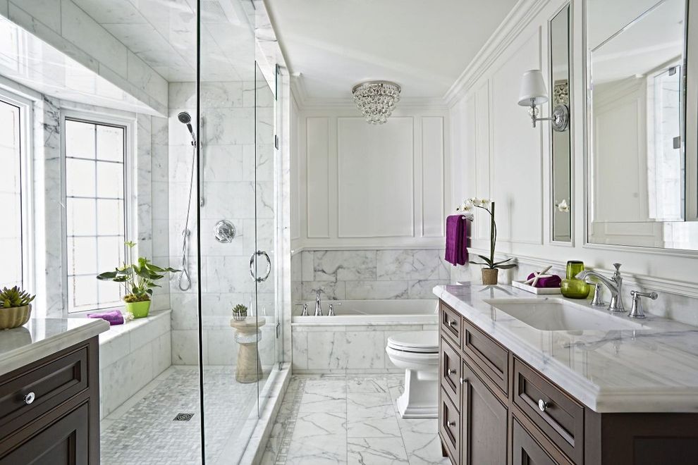 A bathroom with a sink , toilet , tub and walk in shower.