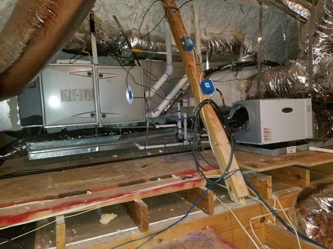 A room with a lot of wires hanging from the ceiling