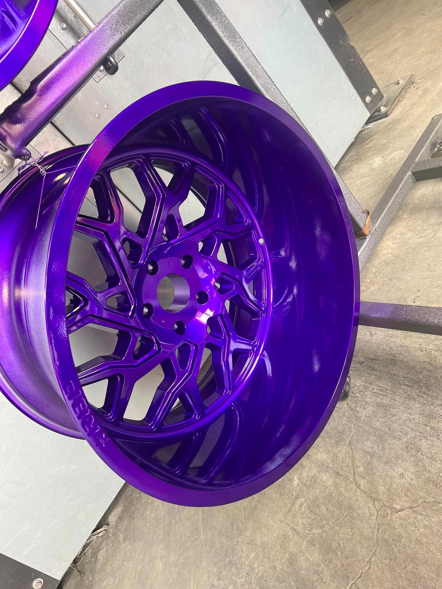a close up of a purple wheel on a stand .