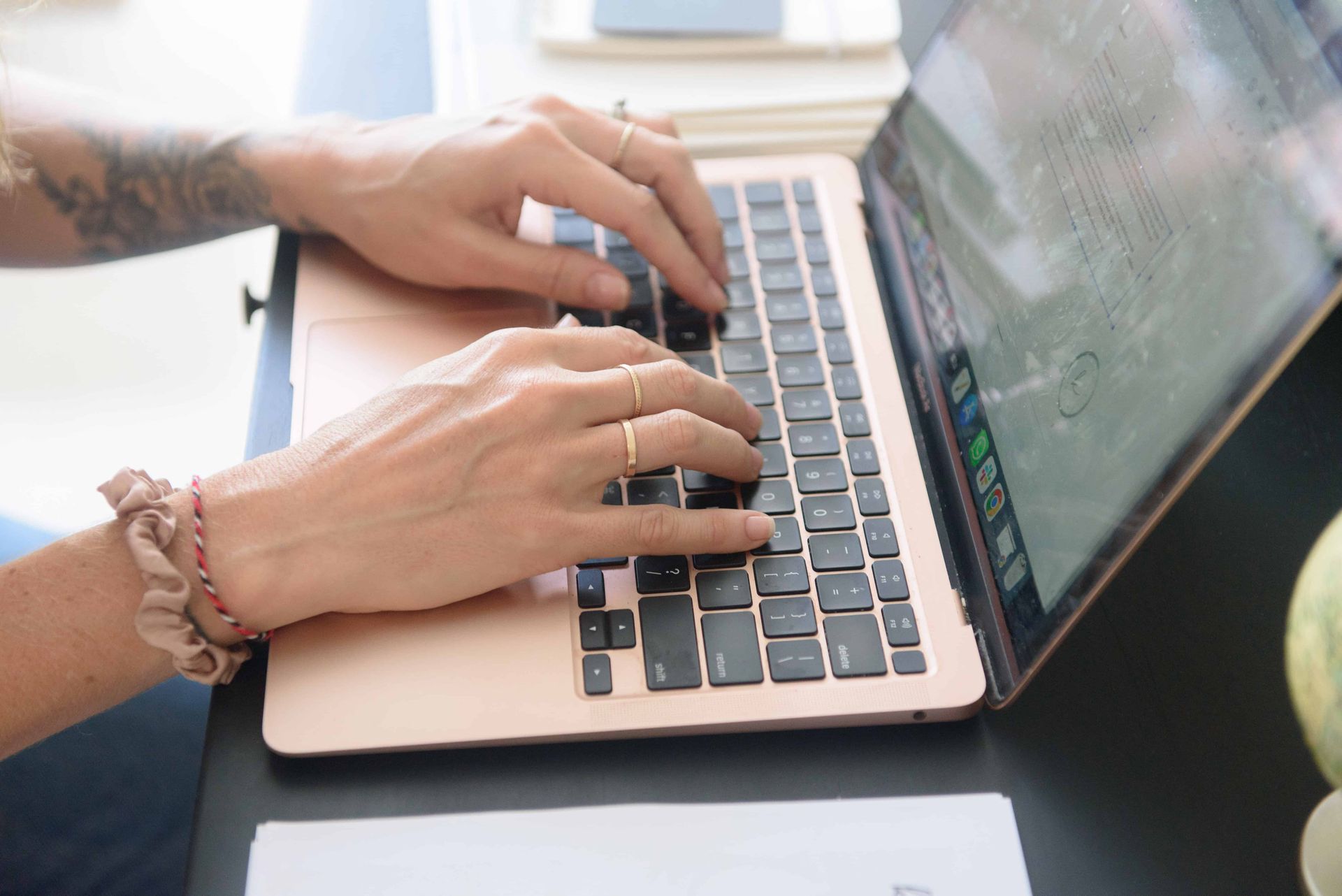 A person is typing on a laptop computer.