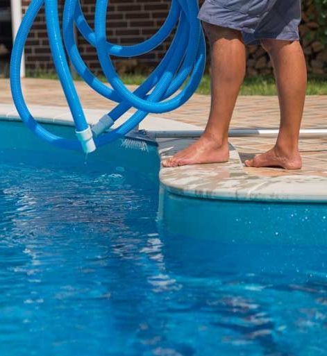 A Large Swimming Pool With Umbrellas And Chairs Around It — Kewba Pools In Erina Heights, NSW