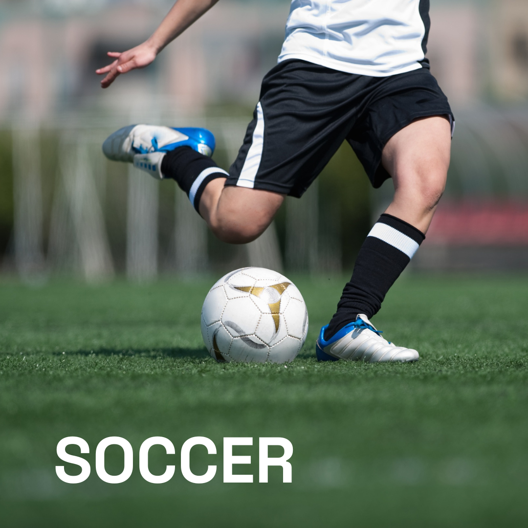 A person in athletic gear kicks a soccer ball on a green field. The word 