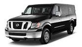 Black Nissan NV passenger van with silver front bumper, parked.