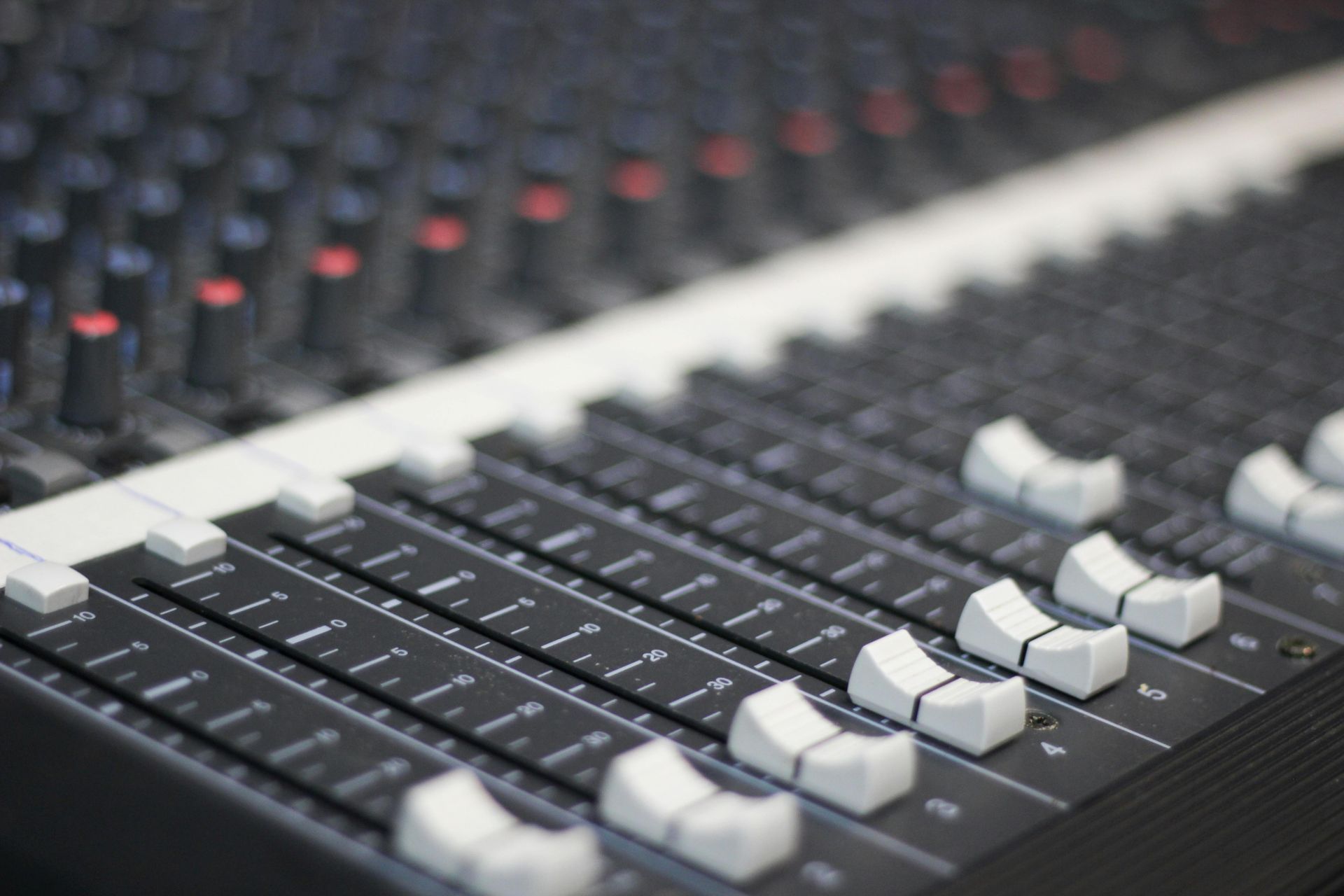 A close up of a mixer with many buttons and knobs