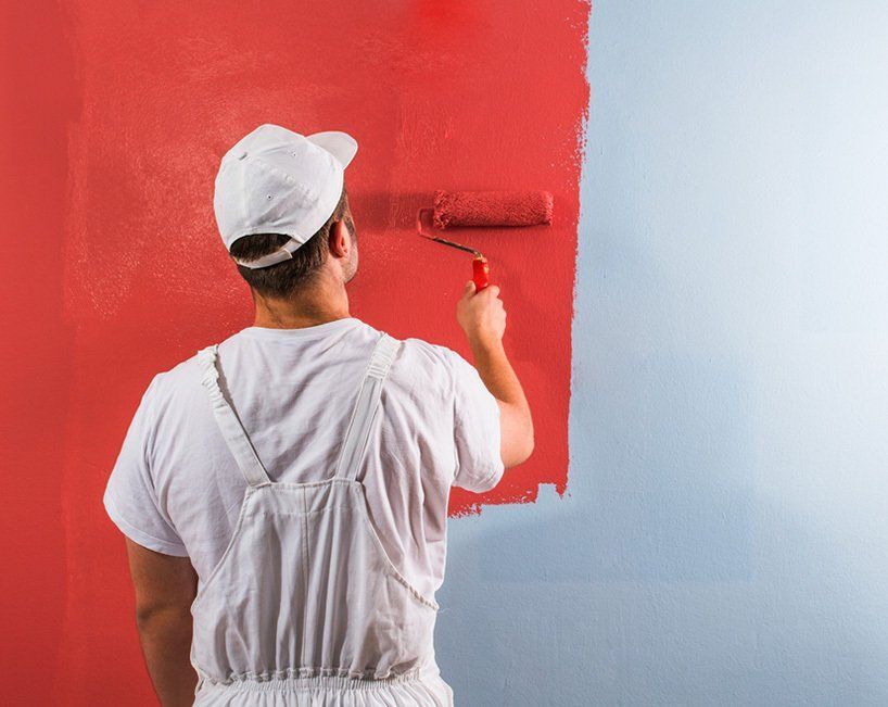 A Person Paints a Wall With a Roller — MDSR Group In Manunda, QLD