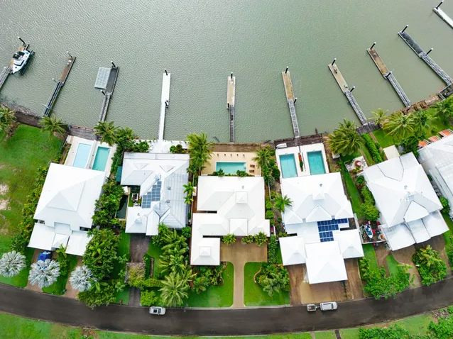 Aerial View of Waterside Homes With White Roofs — MDSR Group In Manunda, QLD