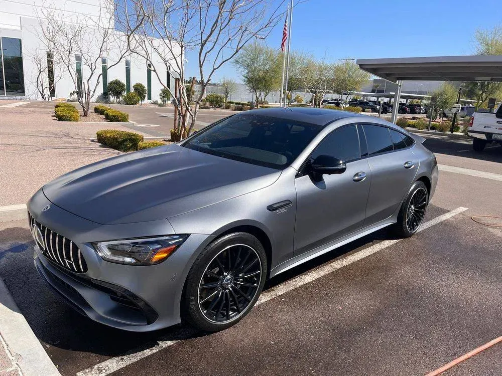 A mercedes benz amg gt 63 s is parked in a parking lot.