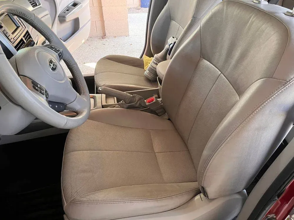 The interior of a car with a steering wheel and seats