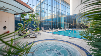 A large swimming pool with a jacuzzi in the middle of it.
