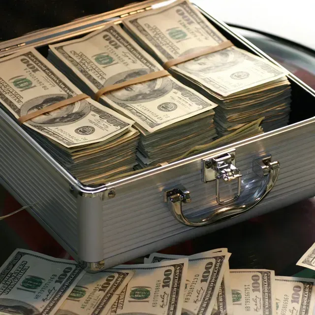 A briefcase filled with stacks of 100 dollar bills