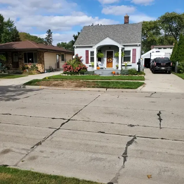 A house with a car parked in front of it
