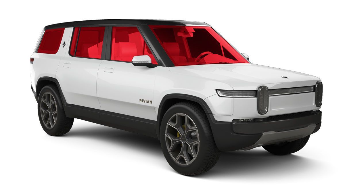White Rivian SUV with black trim, red tinted windows.