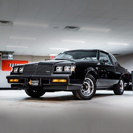 A black car is parked in a garage.