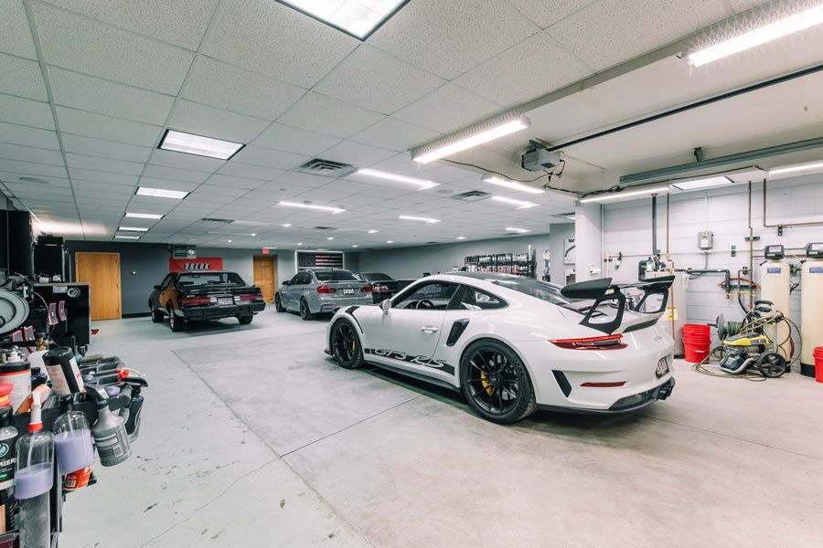 A white porsche 911 gt3 rs is parked in a garage.