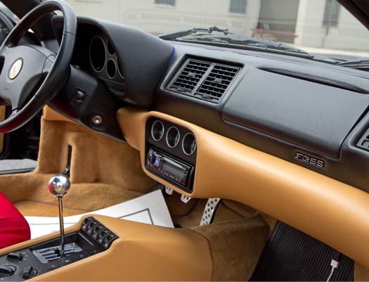 The dashboard of a ferrari sports car with a steering wheel
