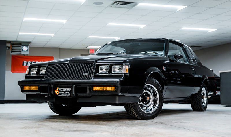 A black car is parked in a garage.