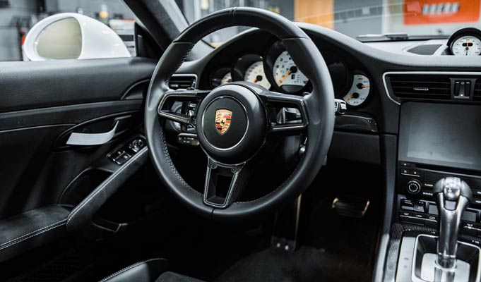 A close up of the steering wheel of a porsche 911 gt3 rs.
