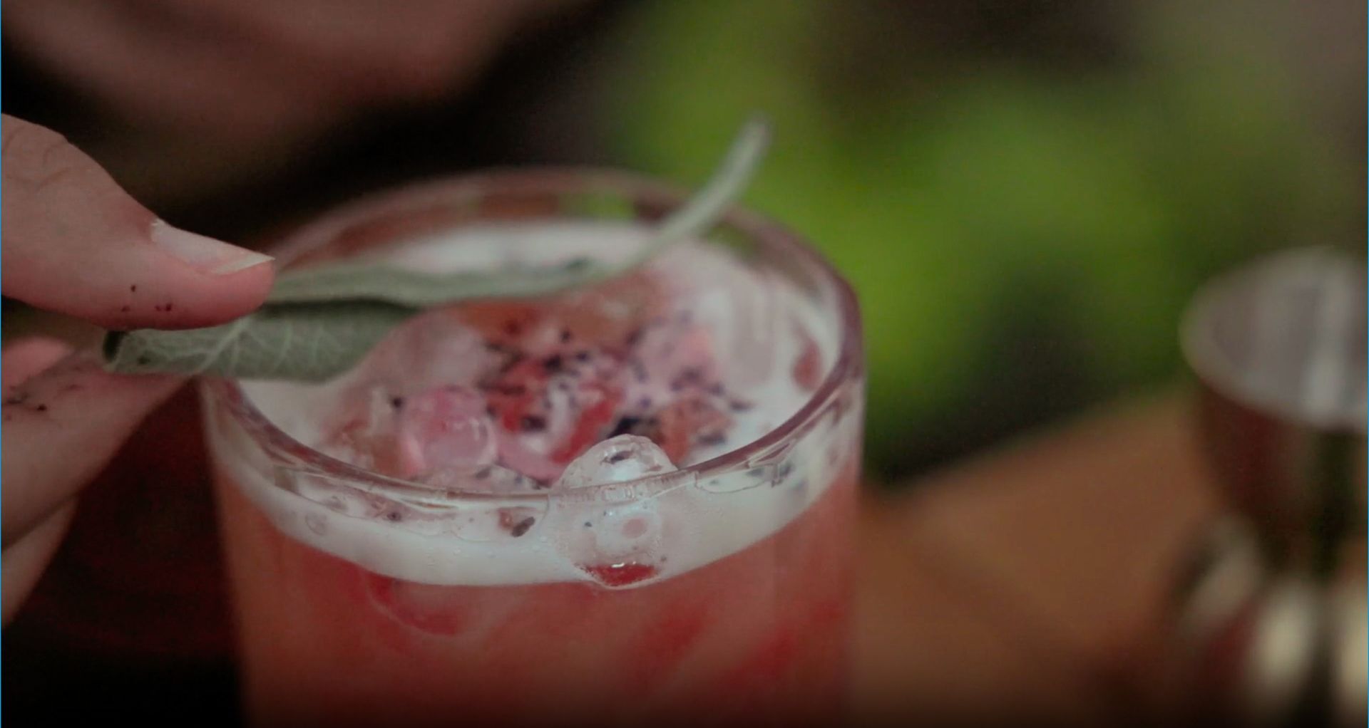 A glass with altarnative beverage topped with herbal alcohol alternative
