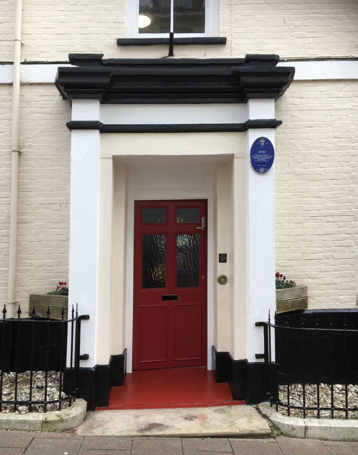Restored traditional front porch and painted entrance of a period property in Lyme Regis, Dorset
