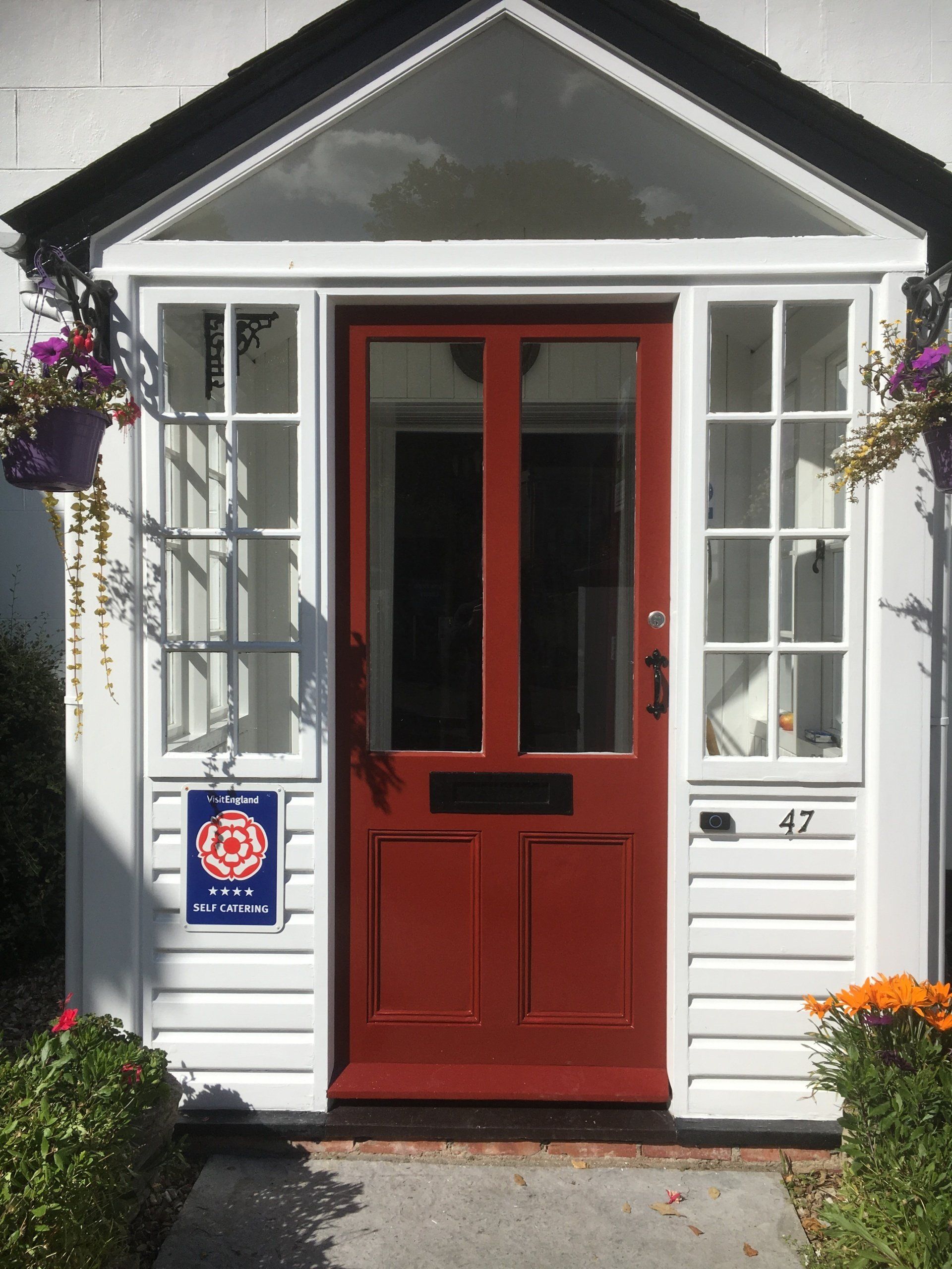 Traditional timber porch and painted front door on a period property in Lyme Regis, Dorset