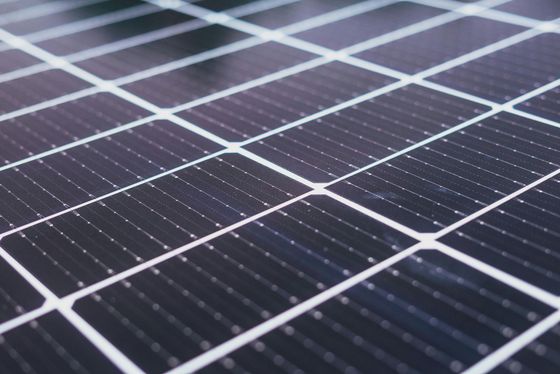 A close up of a solar panel on the ground.