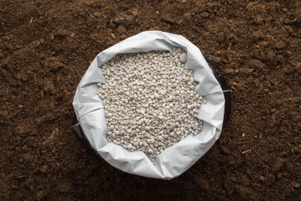 A Bag of Fertilizer Is Sitting on Top of A Pile of Dirt — Kempsey Produce & Saddlery in Kempsey, NSW