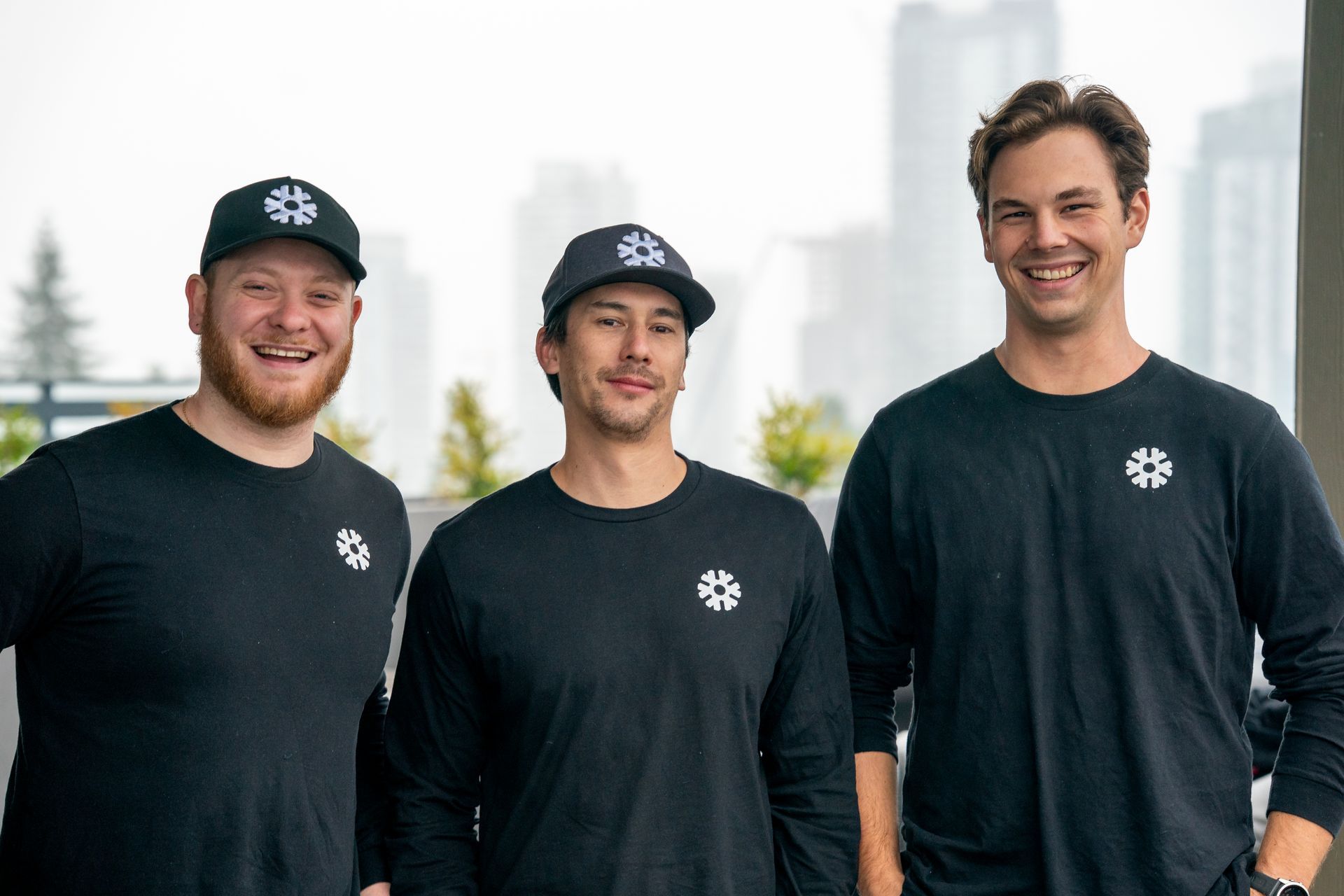 Air conditioner unit outside a brown house near a wooden deck and foliage.