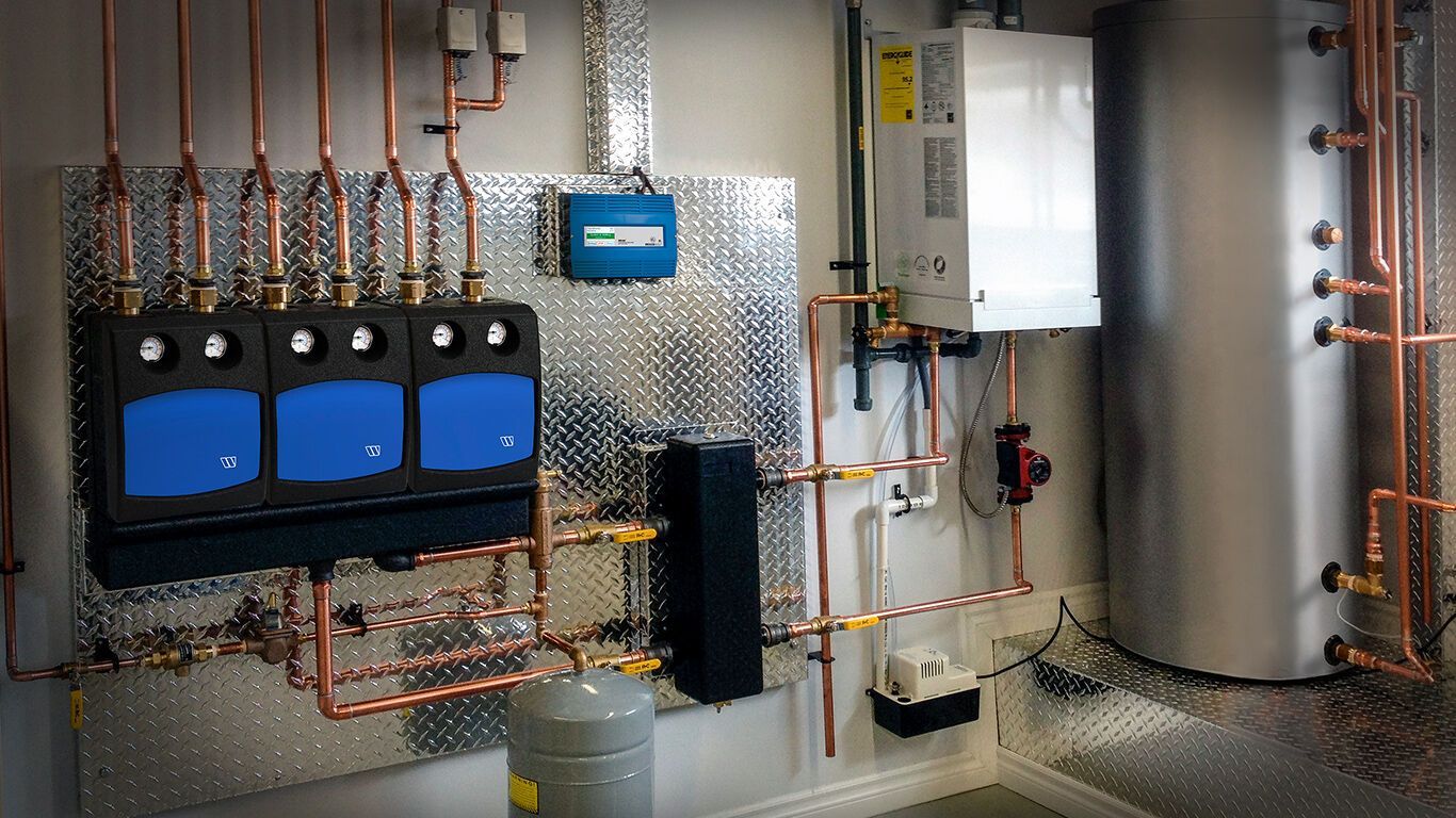 Plumbing system with copper pipes, blue equipment, and a water heater in a utility room.