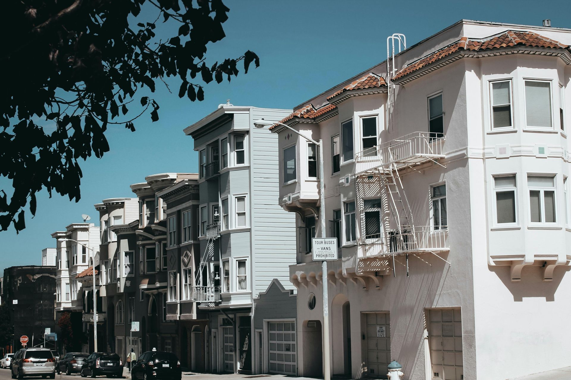 A row of white apartment buildings on a sunny day