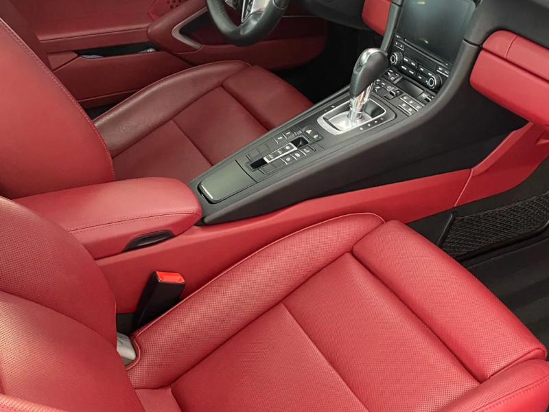 a car with red leather seats and a black console