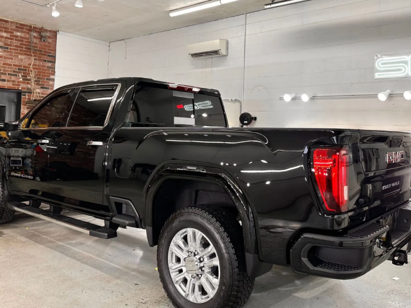 a black pickup truck is parked in a garage .