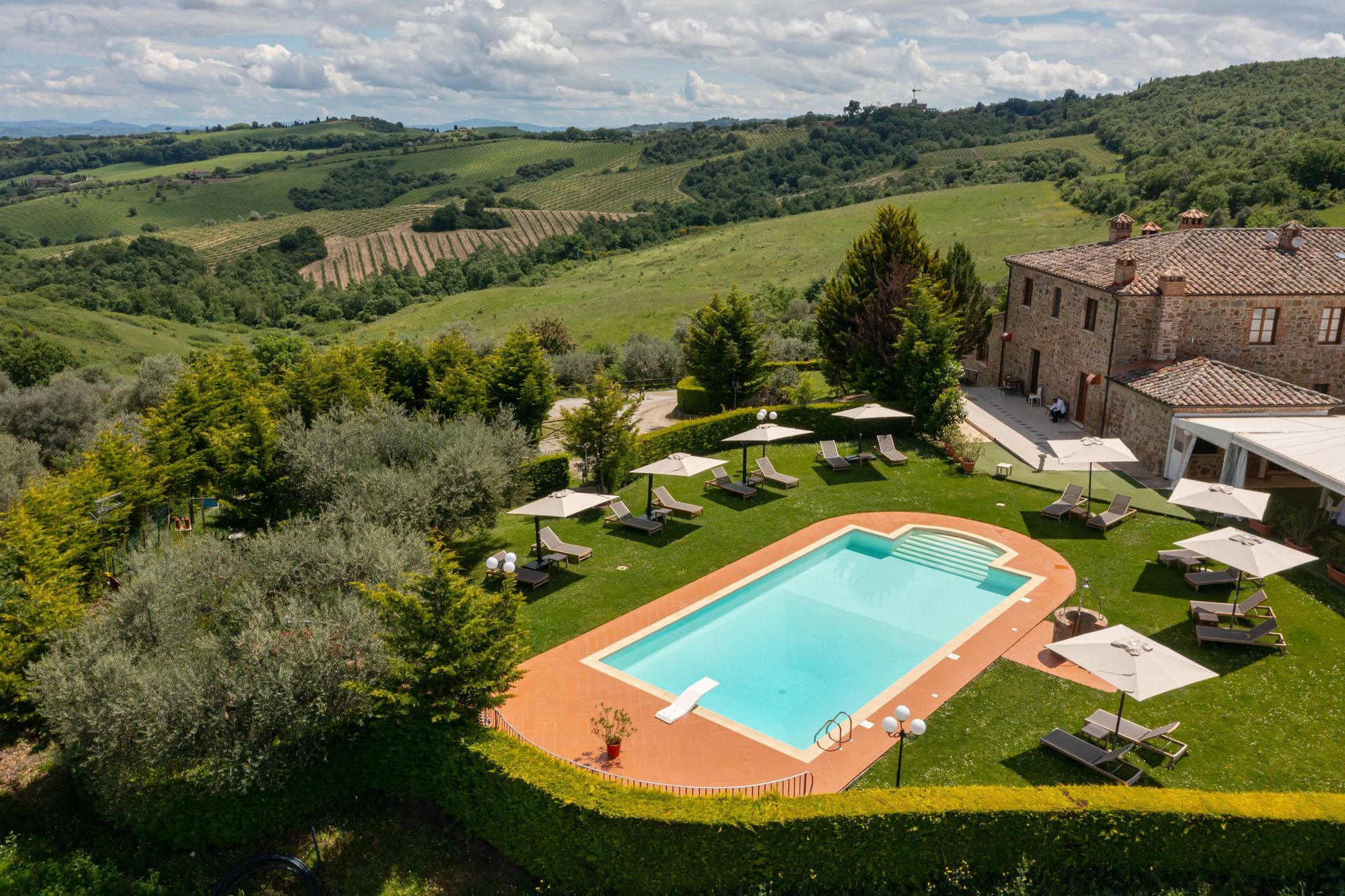An aerial view of Poggio Paradiso's swimming pool in Tuscany.