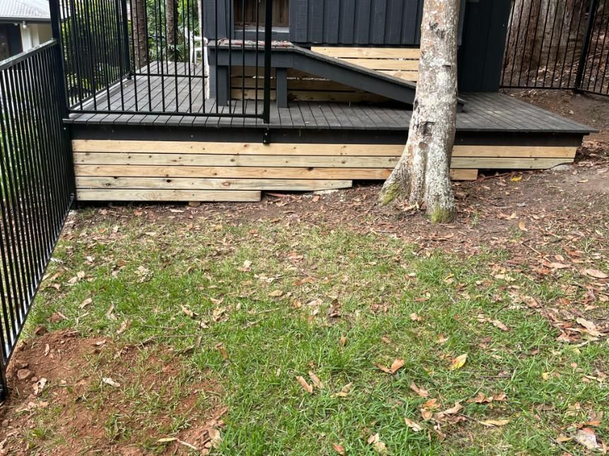 A Wooden Deck Is Being Built In The Backyard Of A House — Lewis Landscapes In Yippin Creek, NSW