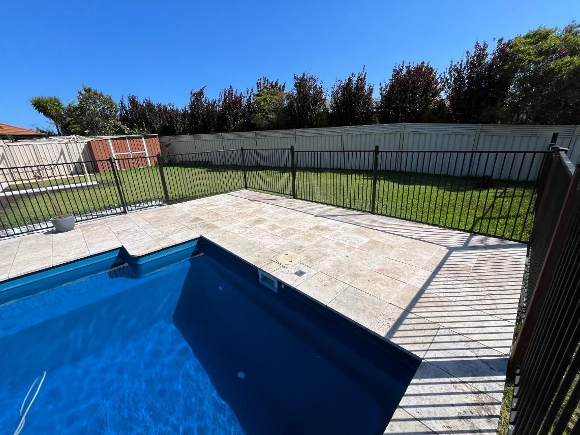 A Large Swimming Pool With A Fence Around It — Lewis Landscapes In Yippin Creek, NSW