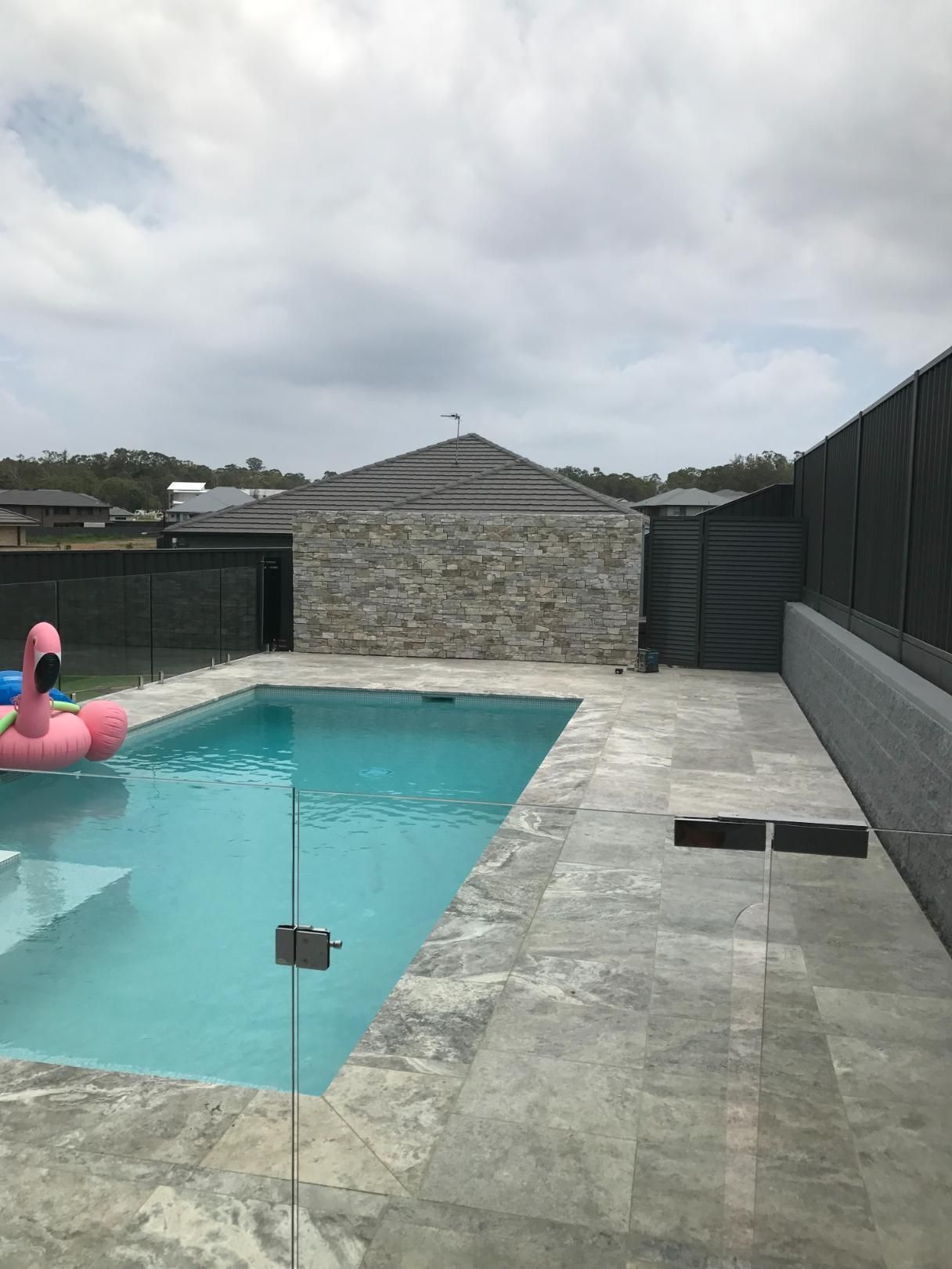 A Swimming Pool With A Pink Flamingo Float In It — Lewis Landscapes In Yippin Creek, NSW