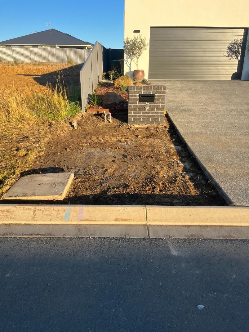 A House With A Garage And A Driveway In Front Of It — Lewis Landscapes In Port Macquarie, NSW