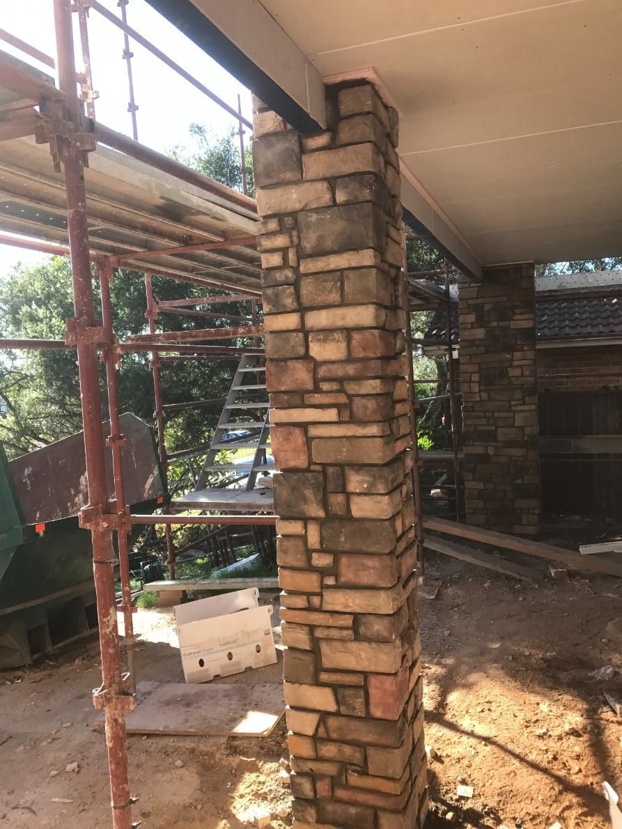 A Brick Column Is Being Built On The Side Of A Building — Lewis Landscapes In Yippin Creek, NSW