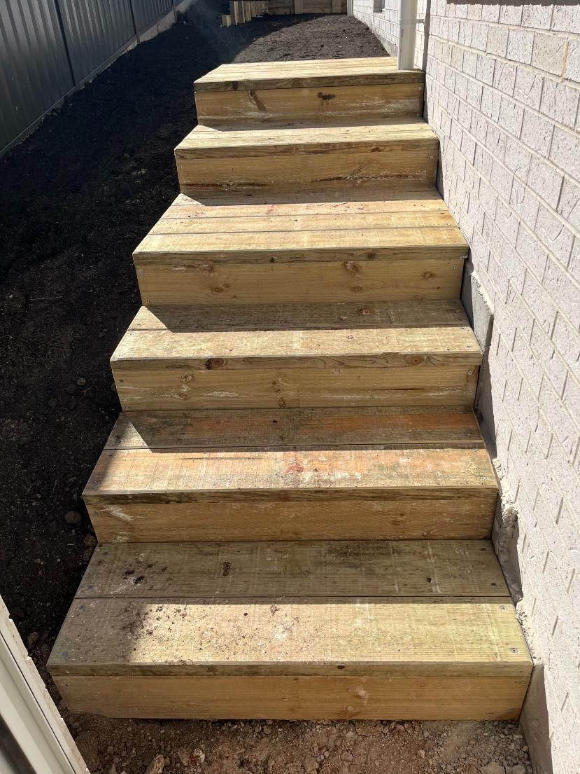 A Set Of Wooden Stairs Leading Up To A House — Lewis Landscapes In Yippin Creek, NSW