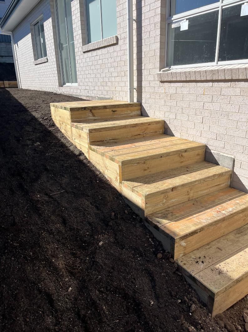A Set Of Wooden Stairs Leading Up To A Brick Building — Lewis Landscapes In Yippin Creek, NSW