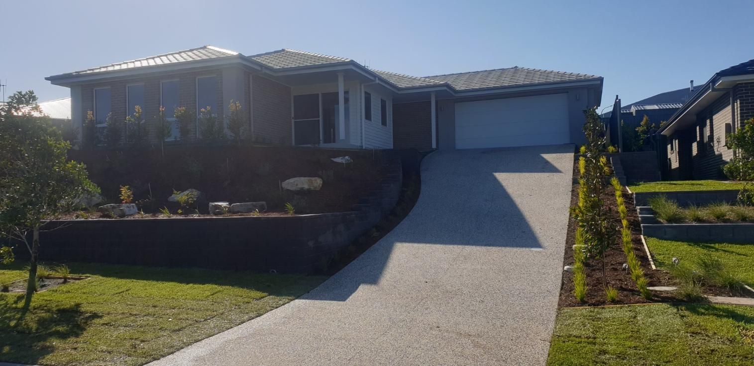 A Large House With A Driveway Leading Up To It — Lewis Landscapes In Laurieton