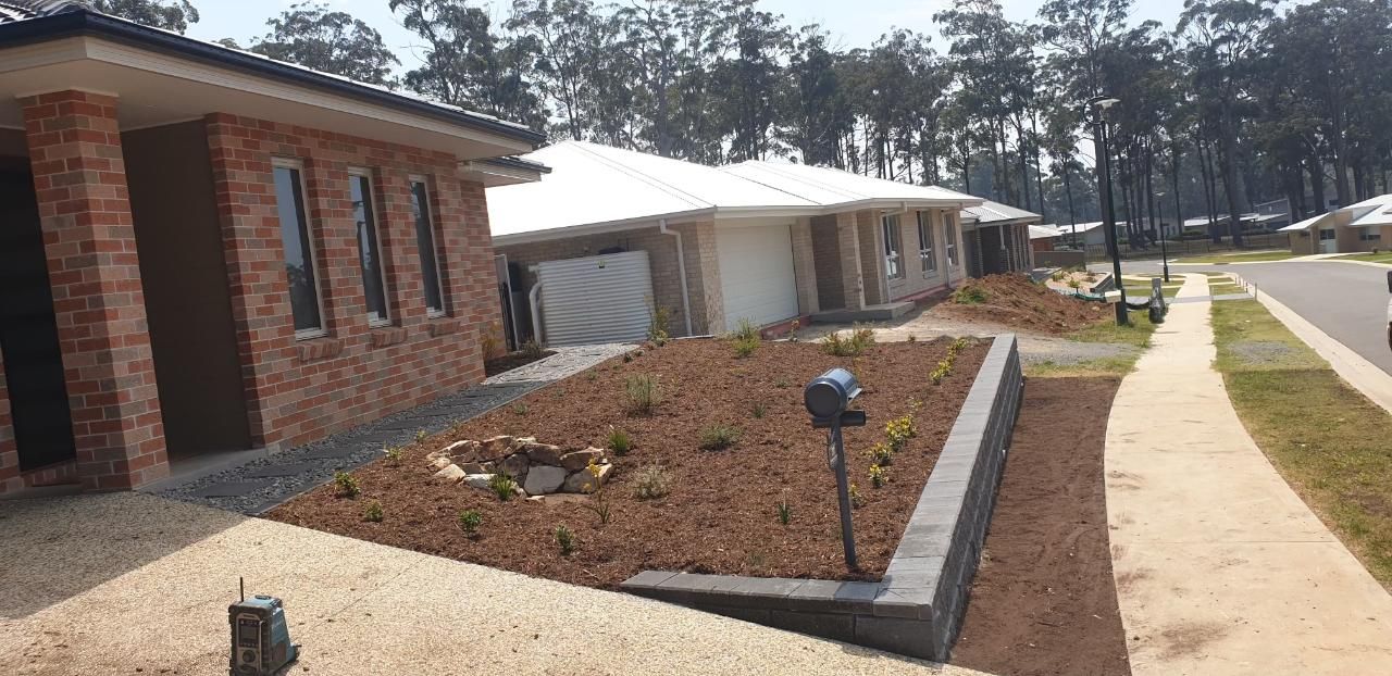 A Row Of Houses Are Sitting Next To Each Other In A Residential Area — Lewis Landscapes In Wauchope, NSW