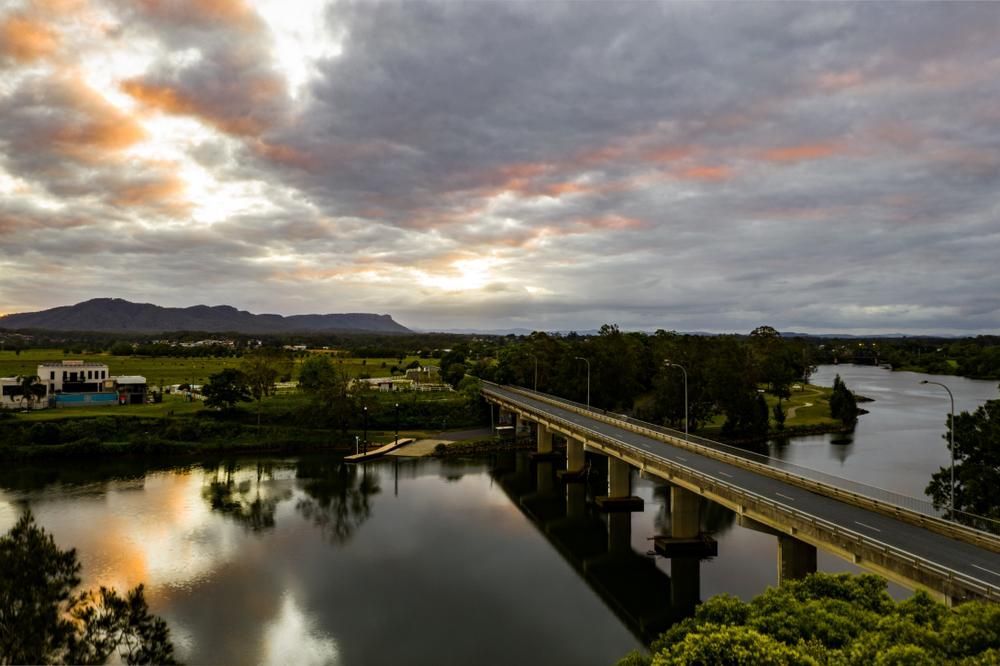 An Aerial View Of A Bridge Over A River At Sunset — Lewis Landscapes In Wauchope, NSW