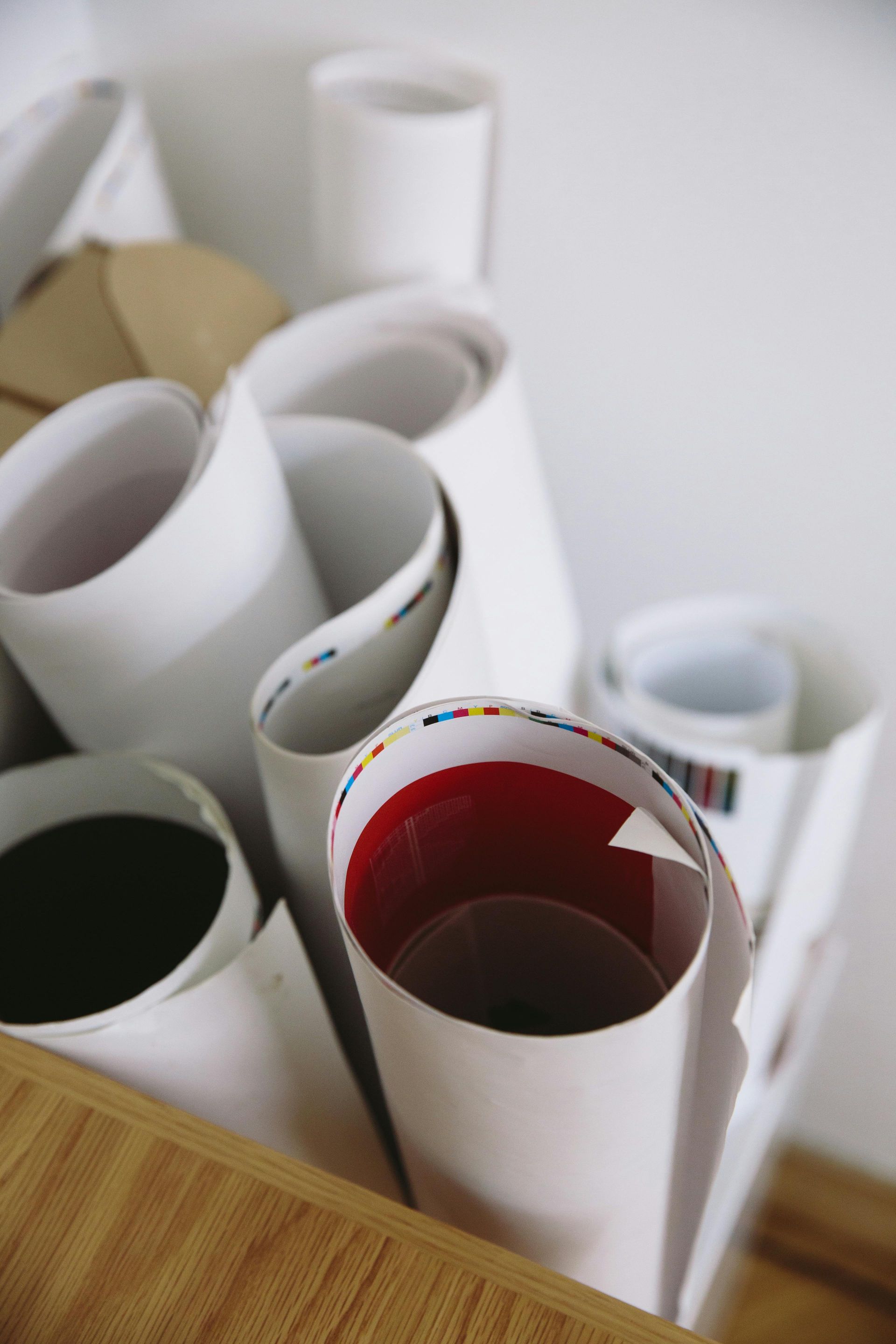 A bunch of rolls of paper on a wooden table