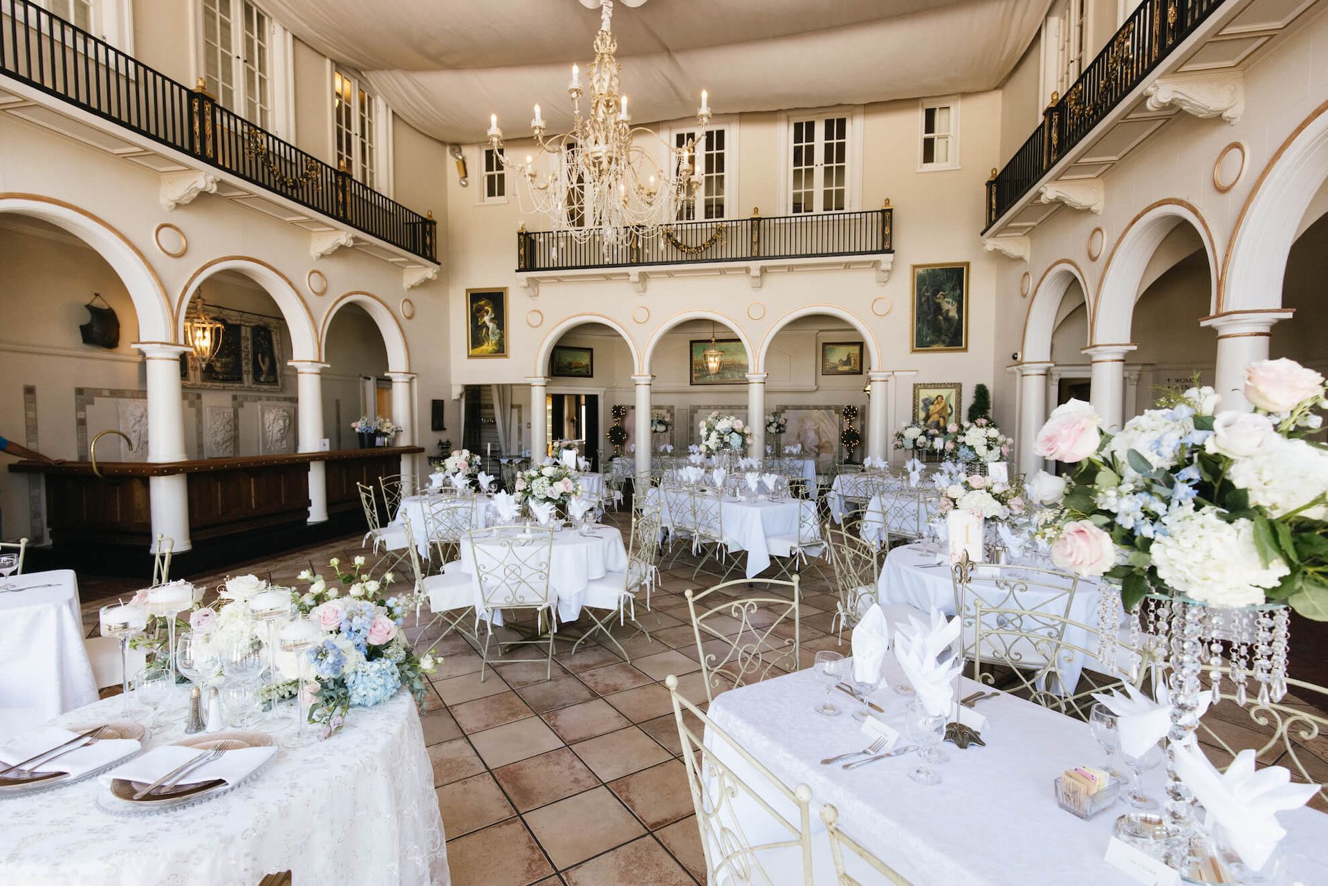 a large room with tables and chairs set up for a wedding reception