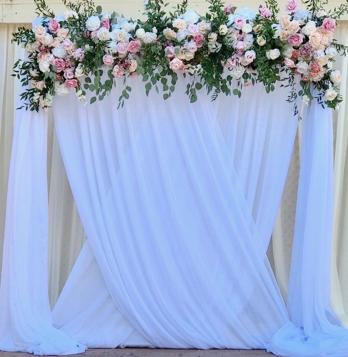 a white draping with pink and white flowers on it