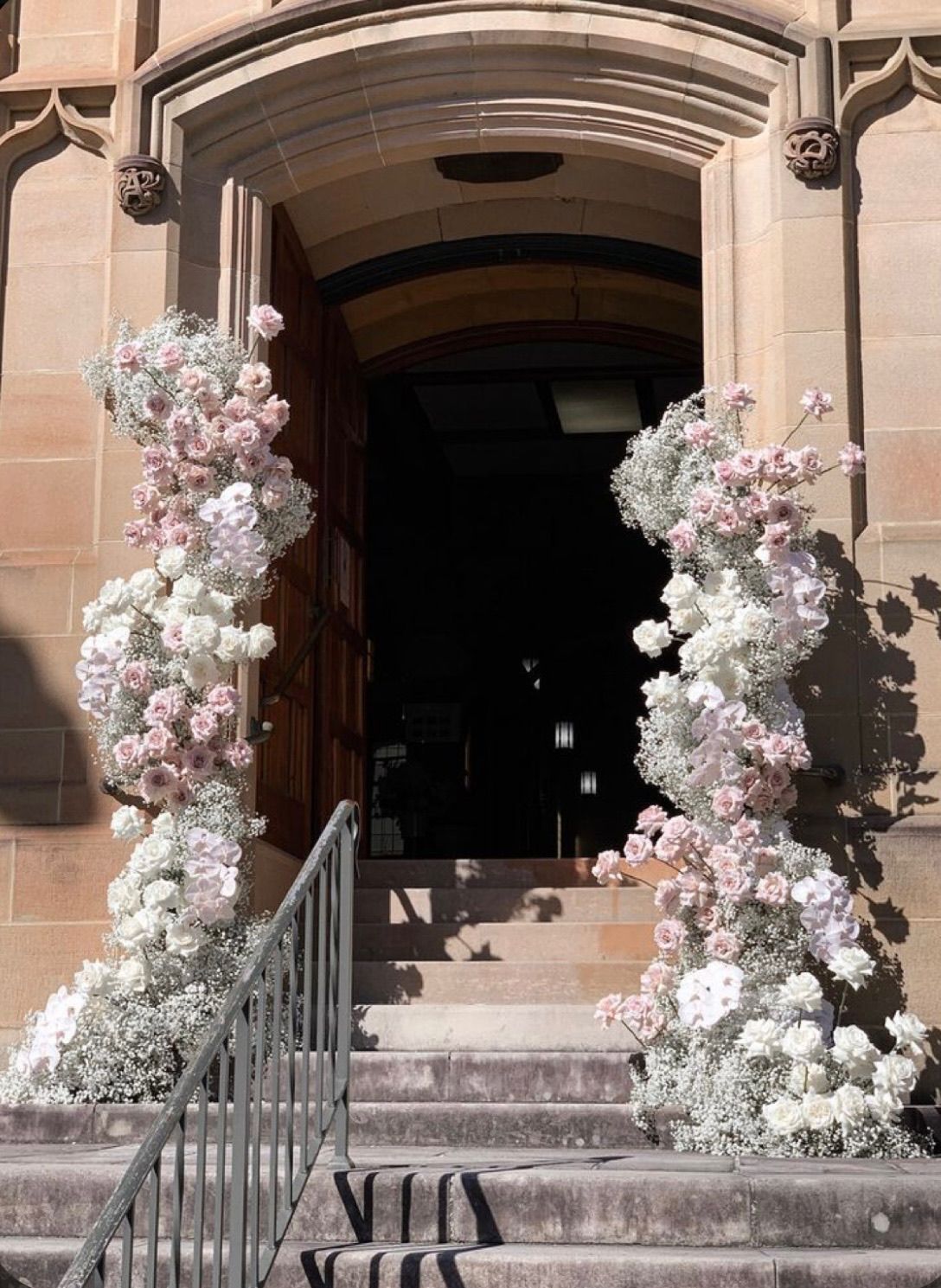 a building with a staircase and flowers on it